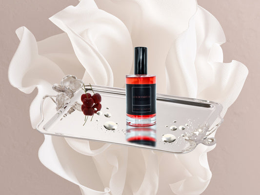Armor Coral Essence Parfum 30 ml bottle with cherries on silver tray and white fabric background
