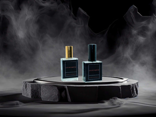Two luxury Bleu Denim perfume bottles on a stone platform with smoky background